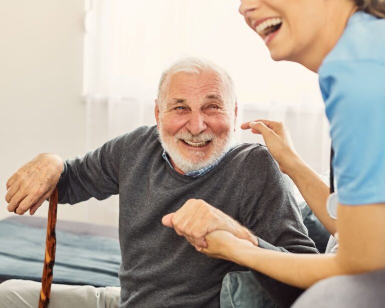 A Maryland senior smiles as he gets assistance from his caregiver.