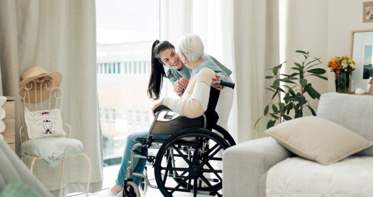 A caregiver helps a client get settled in at home after being discharged from the hospital.