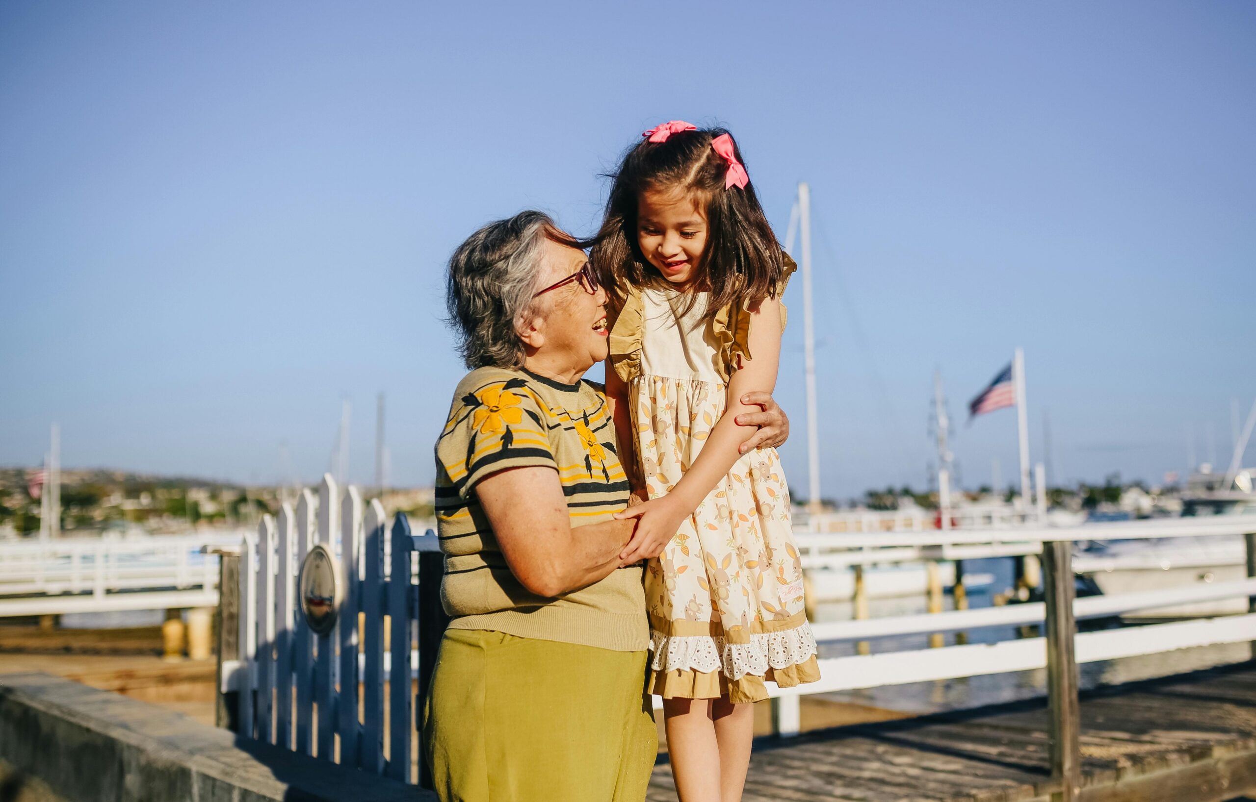 Elderly woman playing with her grandchild at a dock